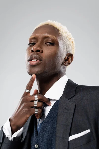 Portrait of elegant african american man in formal wear looking at camera isolated on grey — Stock Photo