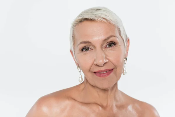 Elderly woman with naked shoulders looking at camera isolated on grey — Stock Photo