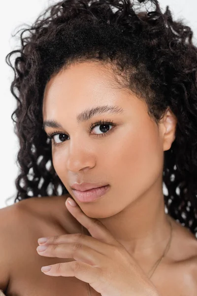 Portrait of african american woman with naked shoulders looking at camera isolated on grey — Stock Photo