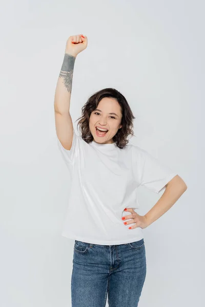 Happy young woman showing yes gesture isolated on grey, feminism concept — Stock Photo