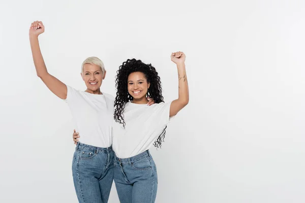 Cheerful interracial women showing yes gesture isolated on grey — Stock Photo