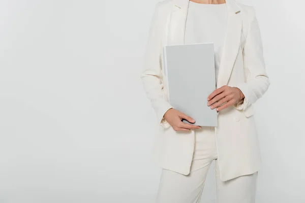 Cropped view of businesswoman in formal wear holding paper folder isolated on grey — Stock Photo