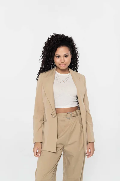 Young african american businesswoman looking at camera isolated on grey — Stock Photo