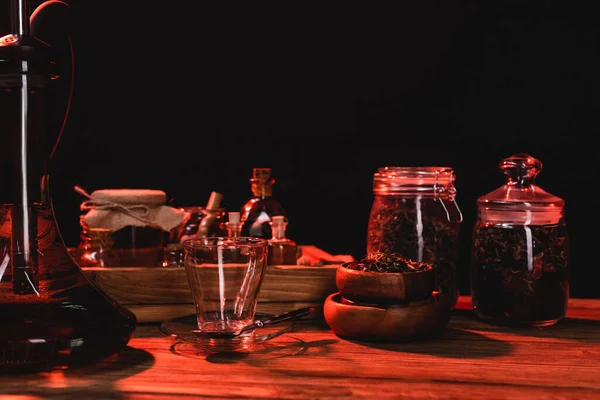 Hookah near dry tea and cup on wooden surface isolated on black — Stock Photo