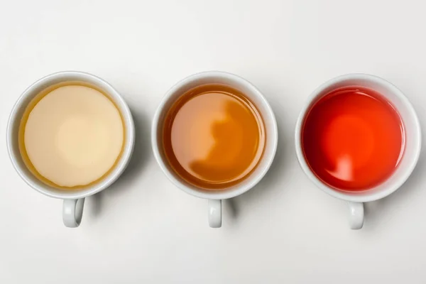 Top view of cups of tea on white background — Stock Photo