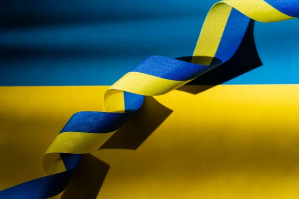 Top view of blue and yellow ribbon on ukrainian flag — Stock Photo