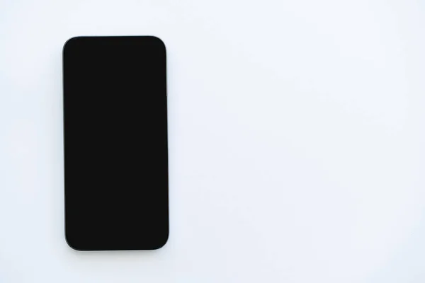 Top view of cellphone with blank screen on white background — Stock Photo