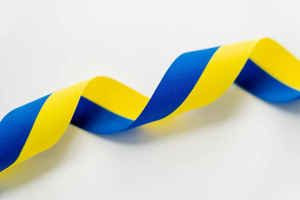 Close up view of curly blue and yellow ribbon on white background — Stock Photo