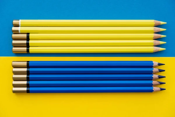 Top view of color pencils on ukrainian flag — Stock Photo