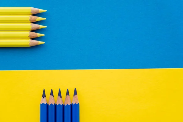 Top view of color pencils on ukrainian flag with copy space — Stock Photo