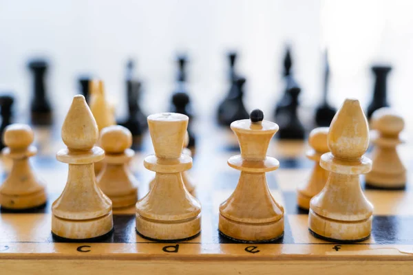 Close up view of wooden chess on board on white background — Stock Photo