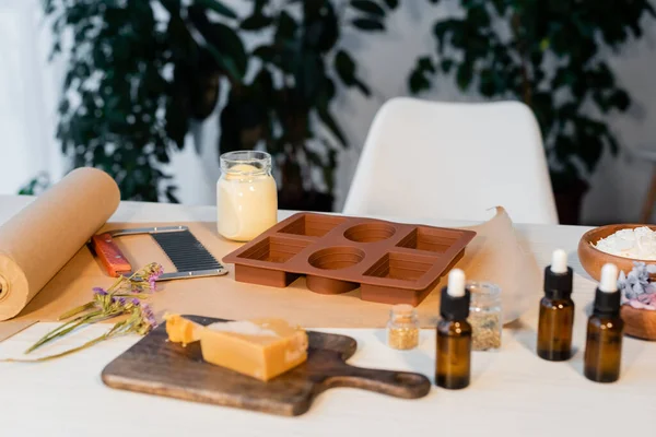 Silicone mold near handmade soap, essential oils and craft paper at home — Stock Photo