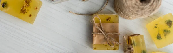 Top view of craft soap bars near twine on table, banner — Stock Photo