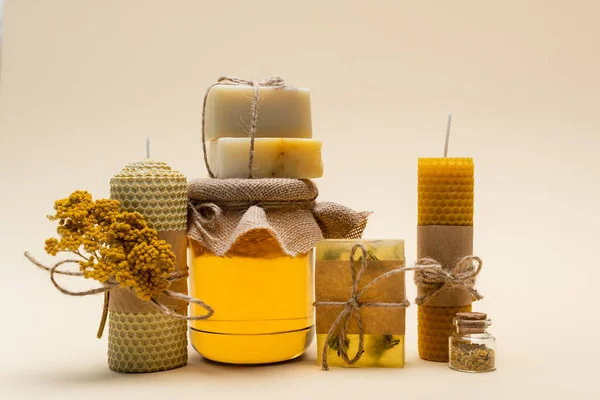 Craft soap and candles near jar with honey on beige background — Stock Photo