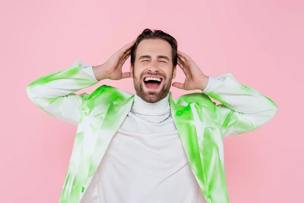 Screaming man in jacket touching head isolated on pink — Stock Photo