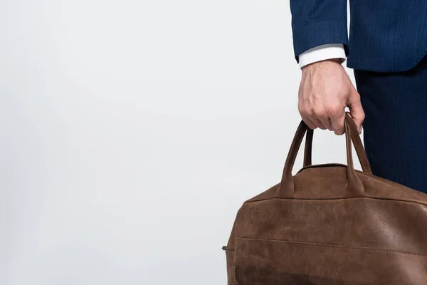 Partial view of economist with leather briefcase isolated on grey — стоковое фото