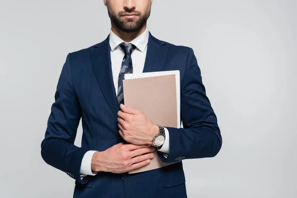 Partial view of economist in blue blazer holding folder isolated on grey — стоковое фото