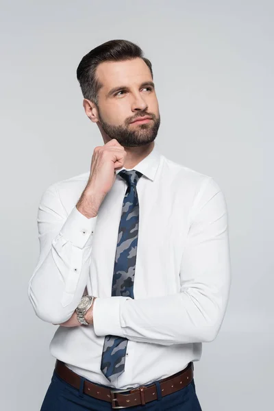 Thoughtful businessman with hand near chin looking away isolated on grey — Stock Photo