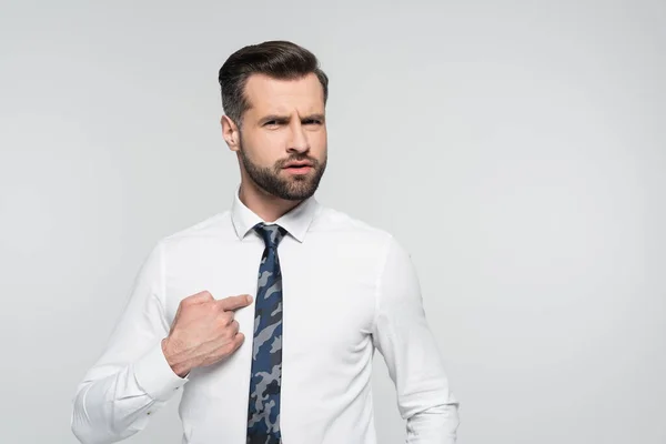 Discouraged businessman pointing with finger and himself isolated on grey — Stock Photo