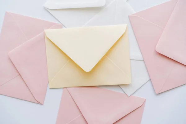 Top view of pastel envelopes on white — Stock Photo