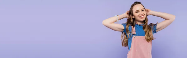 Portrait of happy woman in overall dress isolated on purple, banner — Stock Photo