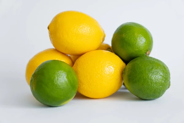 Fresh limes and limes on white surface — Photo de stock