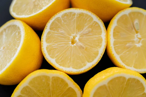 Close up view of juicy lemons isolated on black — Stock Photo