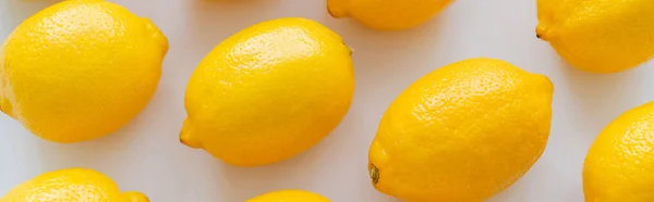 Flat lay with organic ripe lemons on white background, banner — Fotografia de Stock