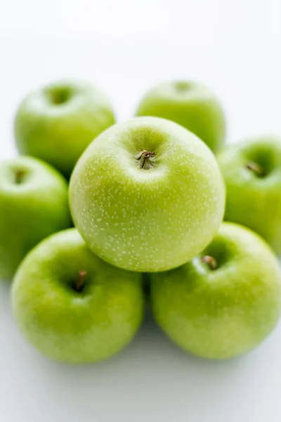 Top view of green and ripe apple on blurred pile on white - foto de stock