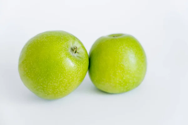 Green and ripe apples on white — Stock Photo