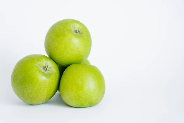 Green and organic apples on white — Stock Photo