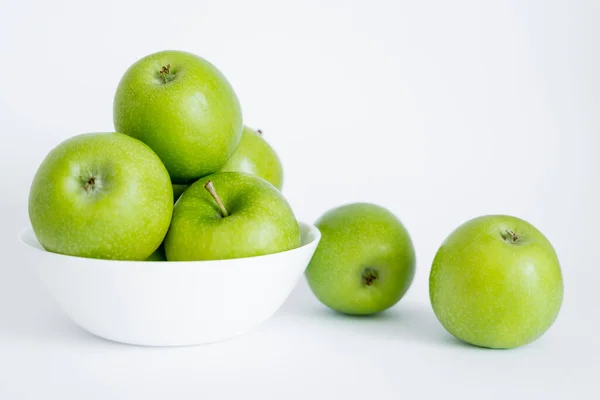 Bowl with green and healthy apples on white — Stock Photo