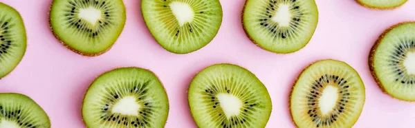 Top view of sliced fresh kiwi on pink, banner — Stock Photo