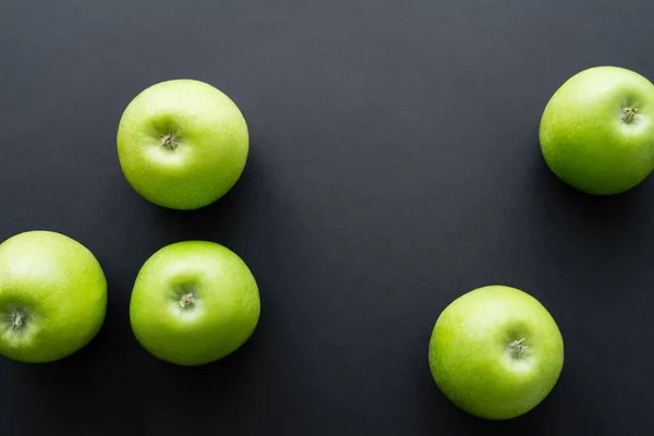 Vista superior de manzanas sanas y verdes en negro - foto de stock