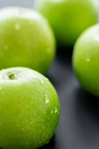 Close up view of fresh apples with water drops on black — Stock Photo