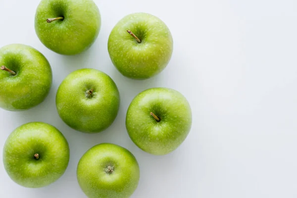 Top view of whole green apples on white with copy space — Stockfoto