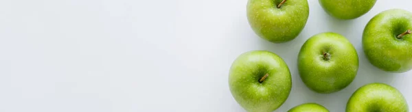 Top view of whole green apples on white with copy space, banner — Stock Photo