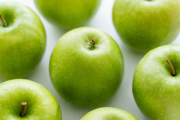 Close up of delicious green apples on white — стоковое фото