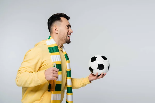 Cheerful man with soccer ball and beer looking away and laughing isolated on grey — Fotografia de Stock