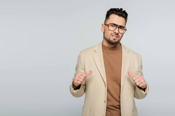 Arrogant critic pointing at himself with thumbs isolated on grey — Foto stock