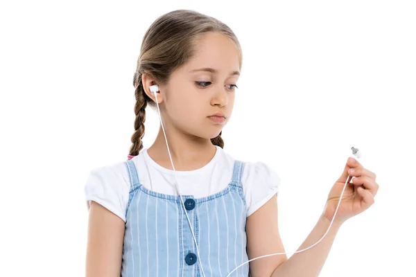 Upset girl looking at broken earphone isolated on white — Stock Photo
