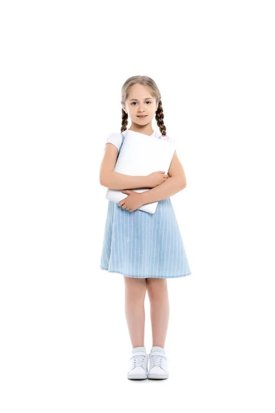 Full length view of girl in blue dress standing with laptop on white — Stock Photo