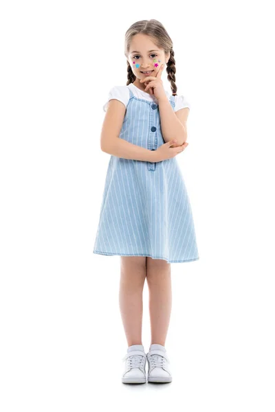 Full length view of girl with colorful stars on face looking at camera on white — Stock Photo