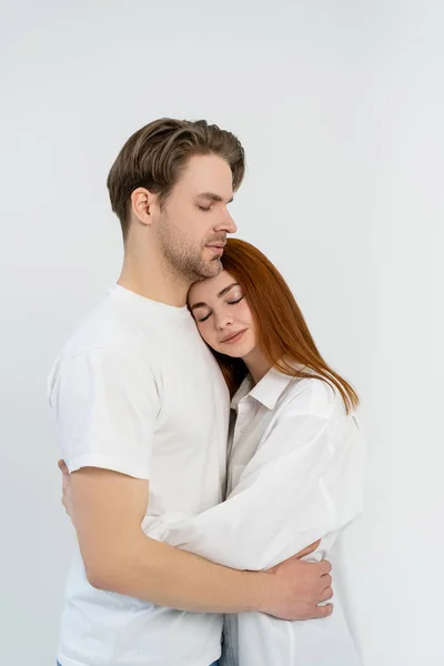 Redhead woman hugging boyfriend isolated on white — Stock Photo