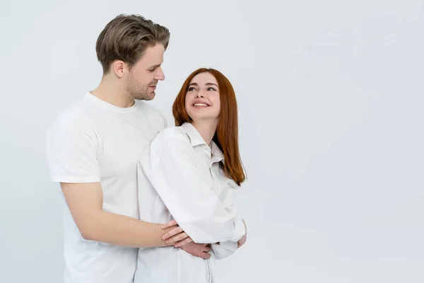 Cheerful woman looking at boyfriend isolated on white — Stock Photo