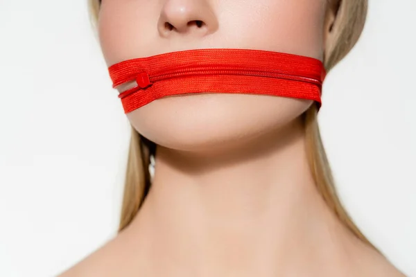 Cropped view of woman with red zipper on mouth isolated on grey — стоковое фото