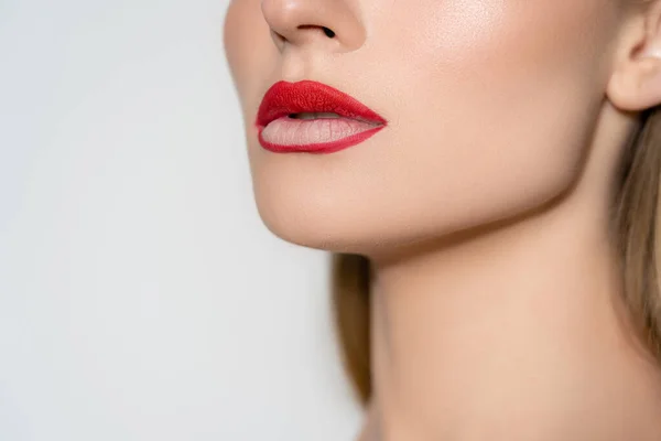 Cropped view of woman with red lips isolated on grey — стоковое фото