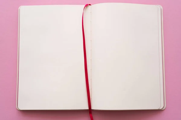 Top view of open and empty notebook on pink — стоковое фото