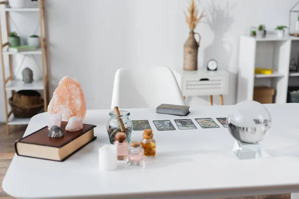 KYIV, UKRAINE - FEBRUARY 23, 2022: Glass orb, magic crystals and tarot cards on table — Stock Photo