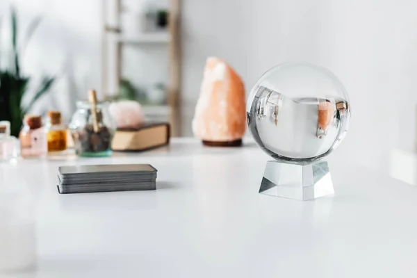 Magic orb near tarot cards on table — стоковое фото